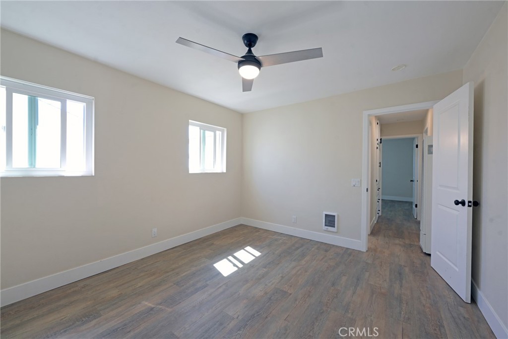 127 East College Street Fallbrook, CA 92028 - Photo 25 of 58 a view of empty room with wooden floor and fan