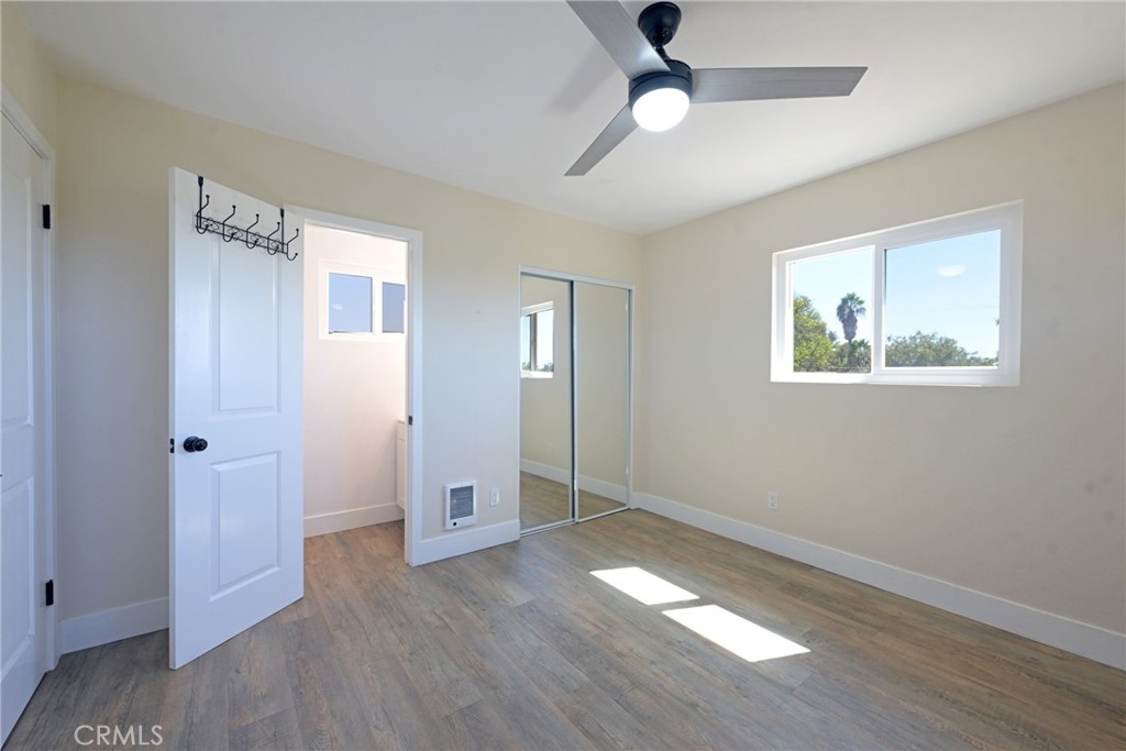 127 East College Street Fallbrook, CA 92028 - Photo 29 of 58 an empty room with wooden floor cabinet and windows