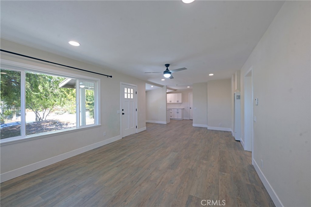 127 East College Street Fallbrook, CA 92028 - Photo 10 of 58 an empty room with wooden floor and windows