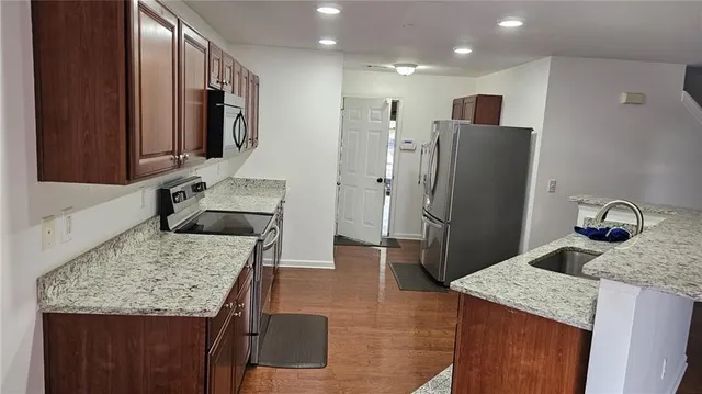a view of empty room with wooden floor and fireplace