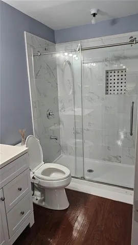 a view of a room with wooden floor