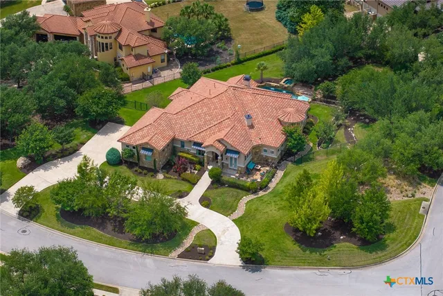 an aerial view of a house with garden space and street view