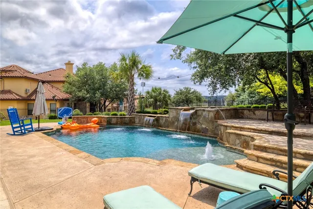 a view of a swimming pool with a lounge chairs
