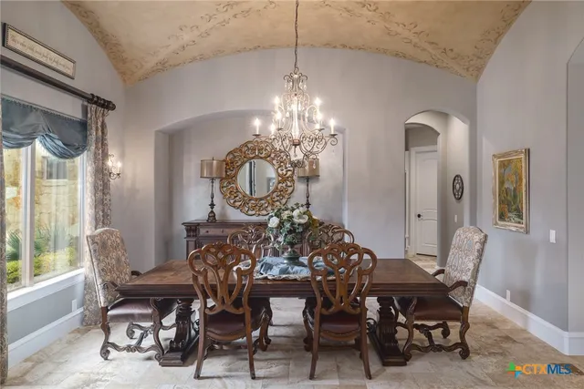 a view of a dining room with furniture and chandelier