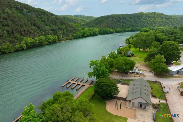 an aerial view of a house with a yard
