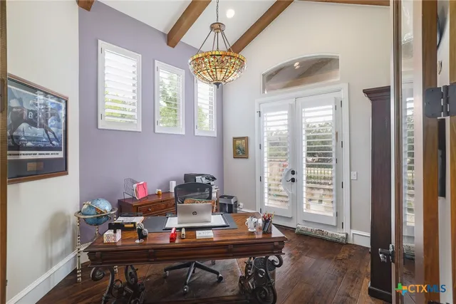 a table and chairs in a room with a window