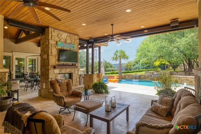a living room with patio furniture and a floor to ceiling window