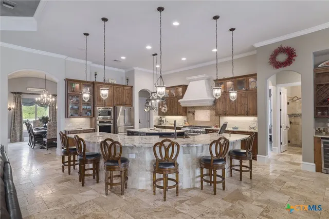 a large kitchen with a table and chairs