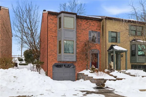 a view of a house with a yard covered in snow