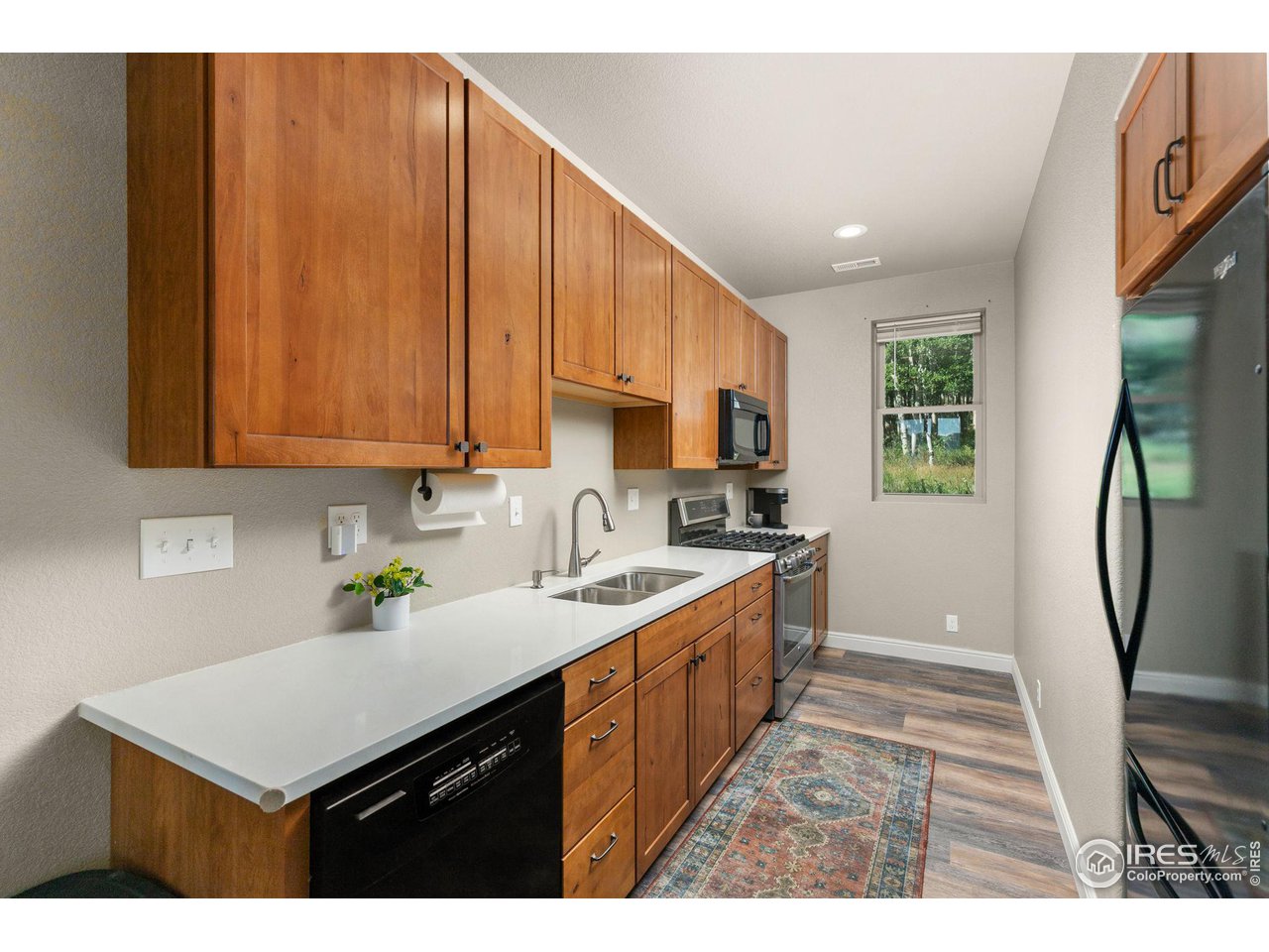 2833 Lump Gulch Road Black Hawk, CO 80422 - Photo 23 of 40 a kitchen with stainless steel appliances a sink a stove a refrigerator cabinets and a window