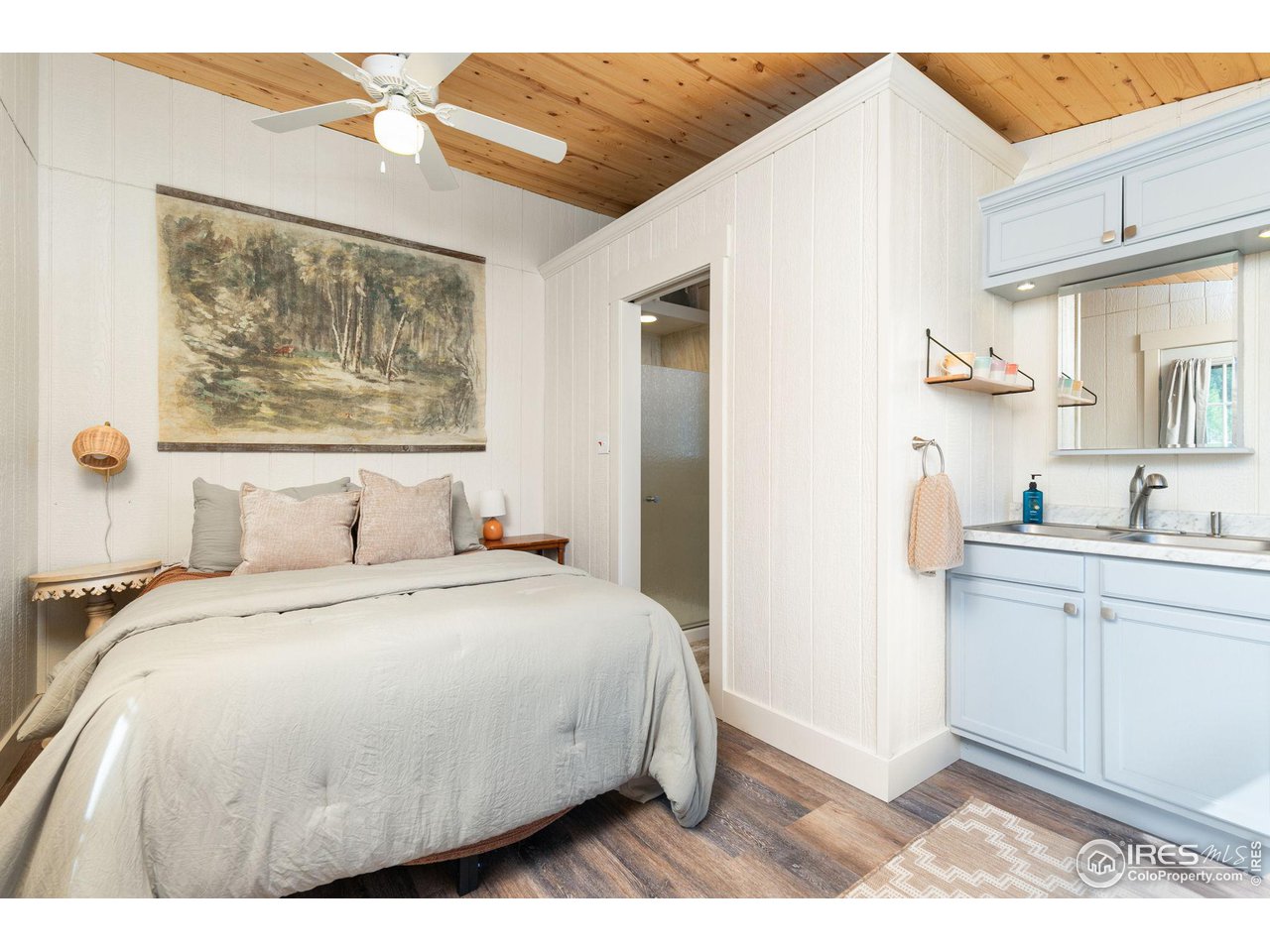 2833 Lump Gulch Road Black Hawk, CO 80422 - Photo 34 of 40 a bedroom with a bed and a painting on the wall