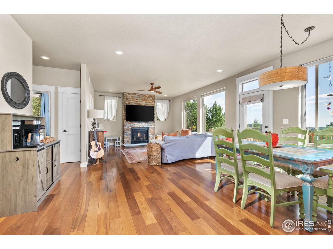 2833 Lump Gulch Road Black Hawk, CO 80422 - Photo 10 of 40 a living room with furniture a flat screen tv and a refrigerator
