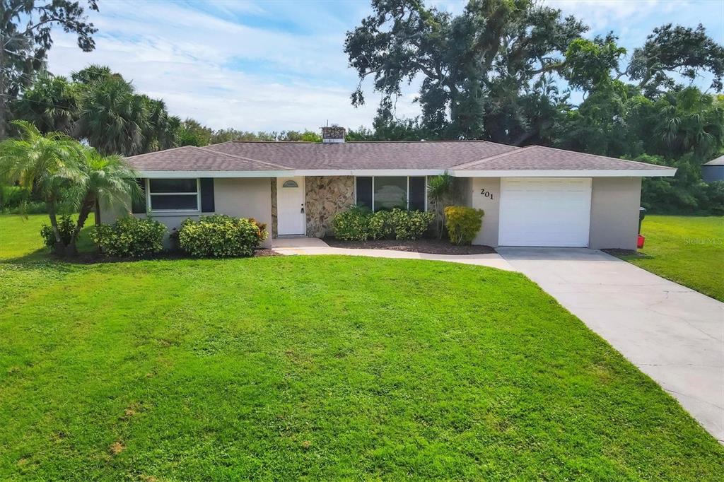 201 Dragon Road Venice, FL 34293 - Photo 1 of 1 a front view of a house with a yard and trees