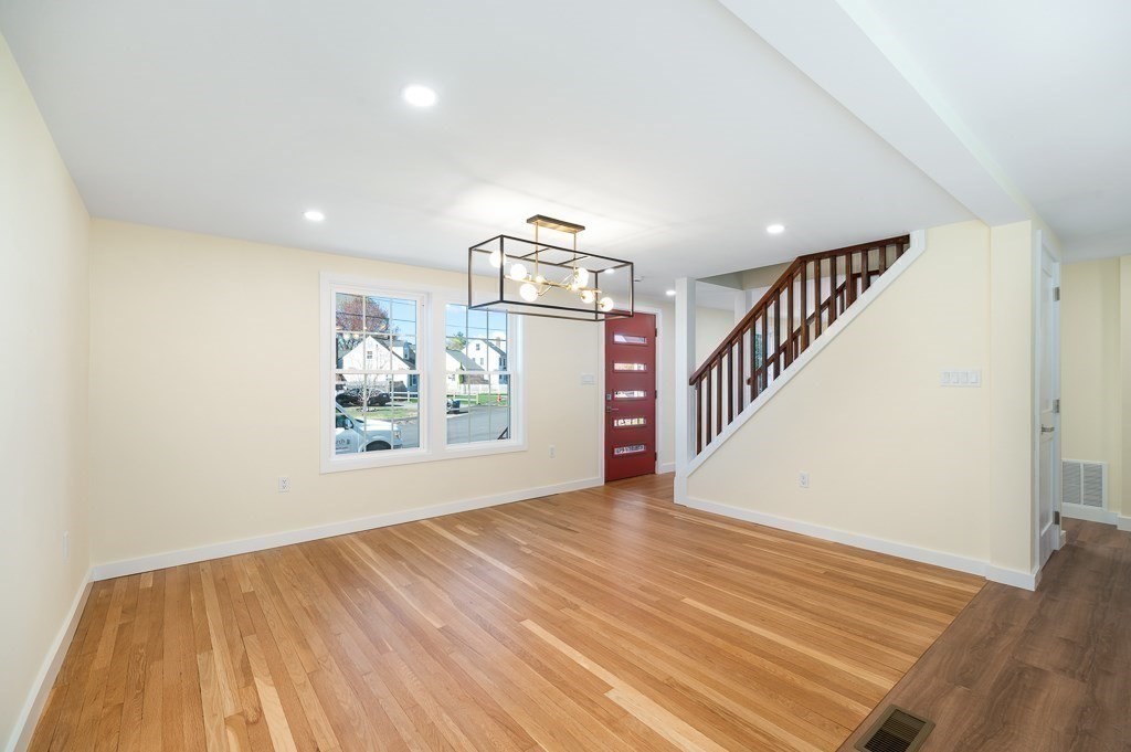 32 Lexington Drive Beverly, MA 01915 - Photo 11 of 41 a view of a hallway with wooden floor and staircase