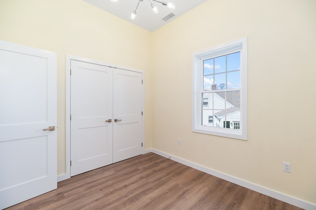 32 Lexington Drive Beverly, MA 01915 - Photo 22 of 41 an empty room with wooden floor closet and windows
