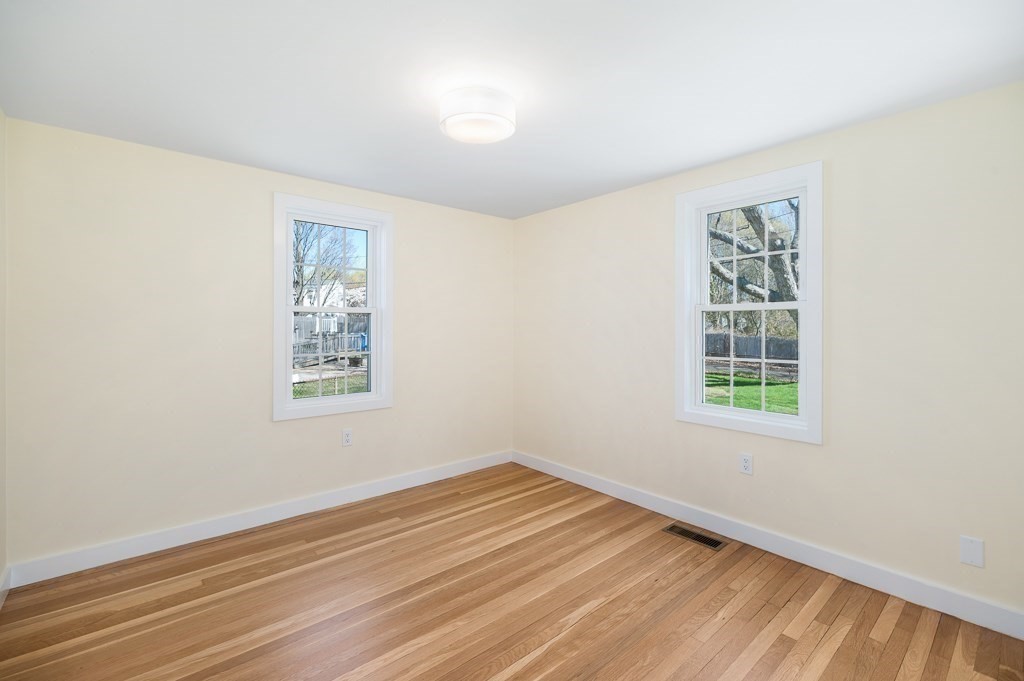 32 Lexington Drive Beverly, MA 01915 - Photo 24 of 41 a view of an empty room with wooden floor and a window