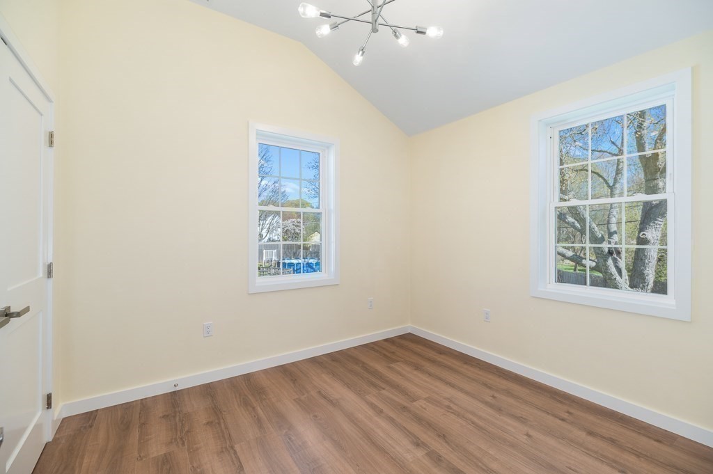 32 Lexington Drive Beverly, MA 01915 - Photo 25 of 41 an empty room with wooden floor and windows