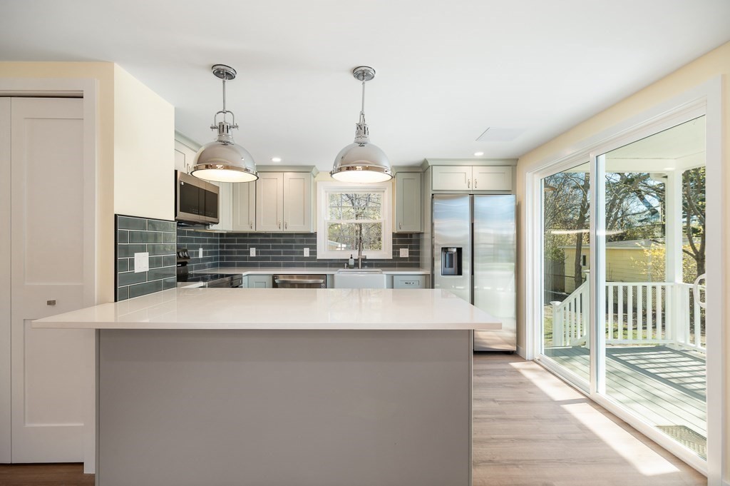 32 Lexington Drive Beverly, MA 01915 - Photo 5 of 41 a large white kitchen with a large window