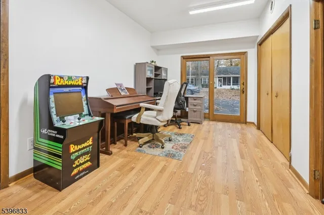 a view of a workspace with furniture and a window