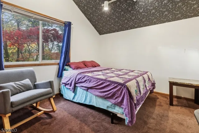 a bedroom with a bed chair and window