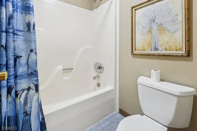 a white toilet sitting next to a bathroom sink