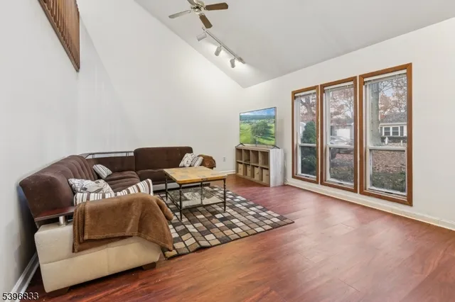 a living room with furniture and a floor to ceiling window