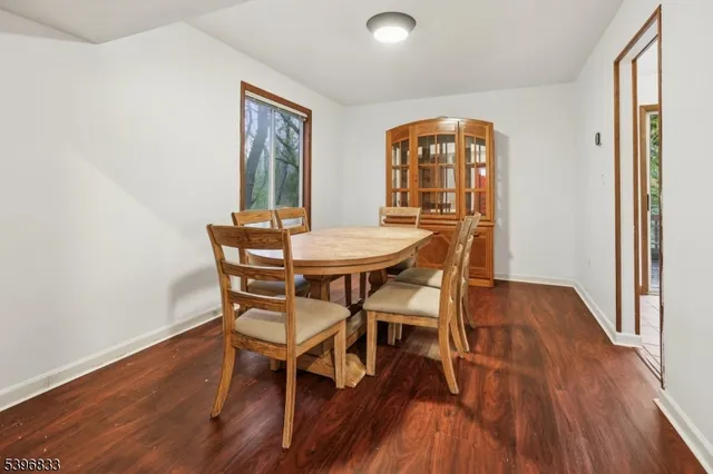 a dining room with furniture and wooden floor