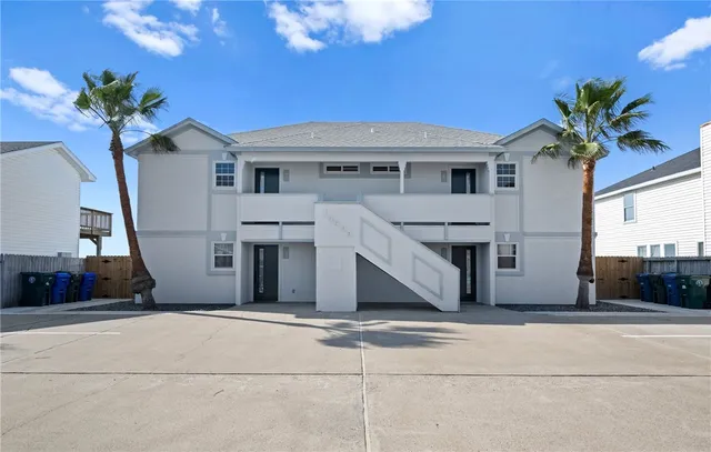 a view of a house with a potted plant and a large window