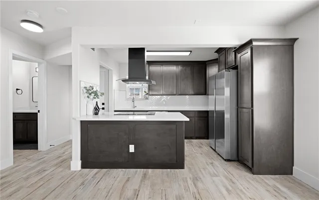 a kitchen with stainless steel appliances a sink and a refrigerator