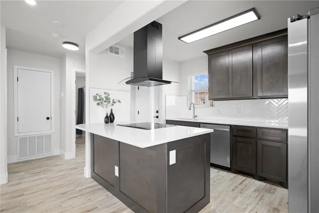 a kitchen with a sink stove and refrigerator