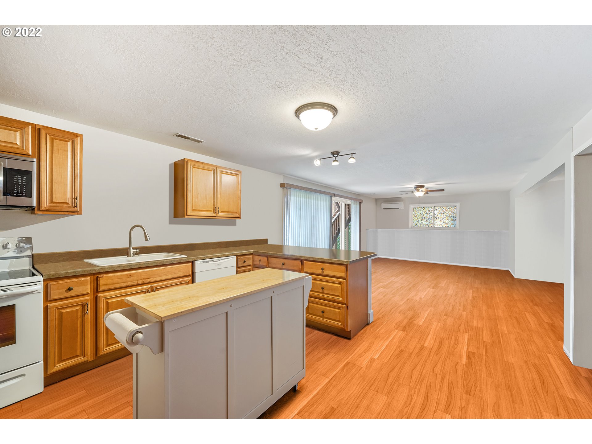8020 Greentree Ridge Road Tillamook, OR 97141 - Photo 20 of 31 a kitchen with stainless steel appliances granite countertop a sink dishwasher stove and wooden cabinets