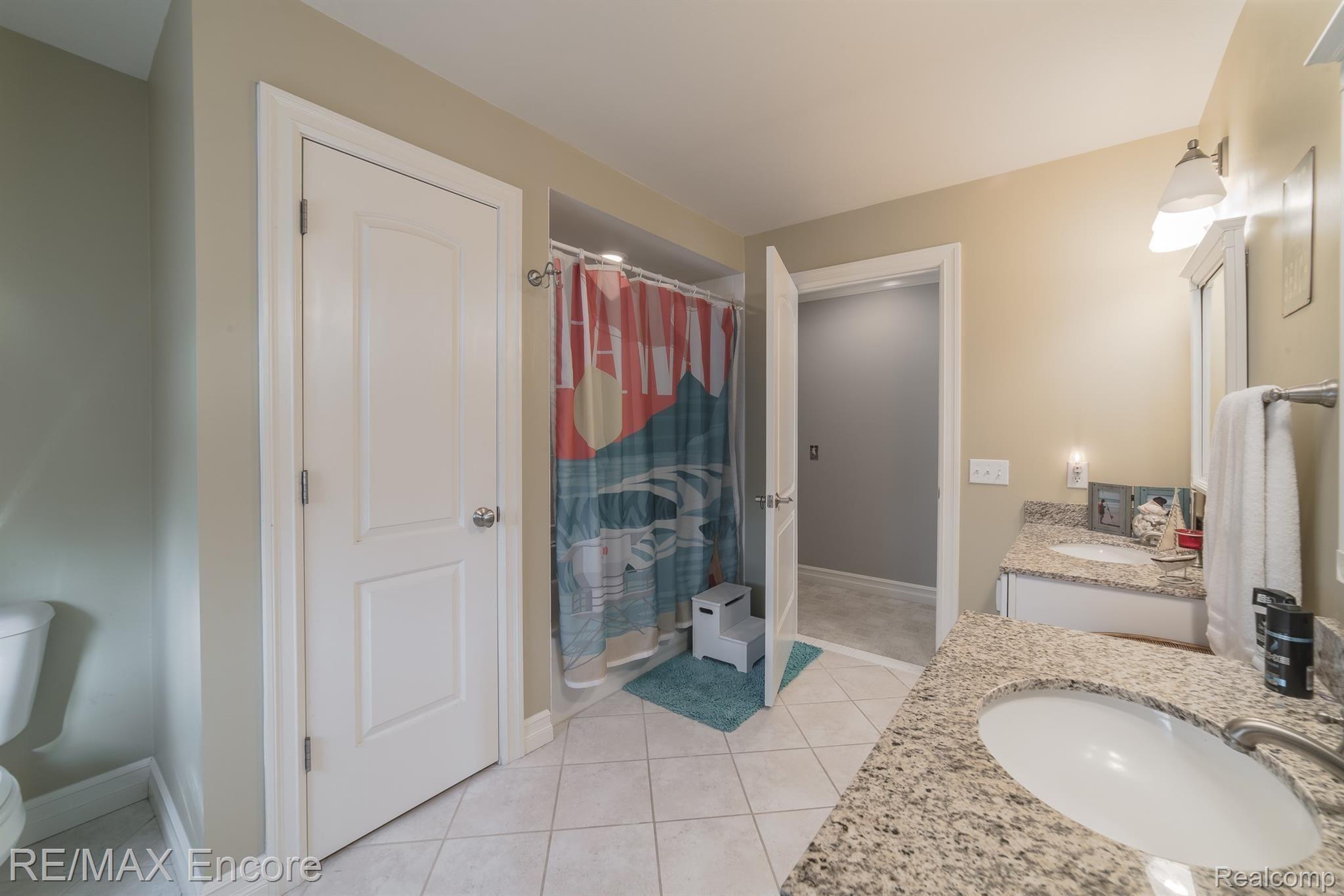 7686 Devins Ridge Clarkston, MI 48348 - Photo 37 of 58 Oversized full bath with 2 vanities with granite and ceramic tile flooring