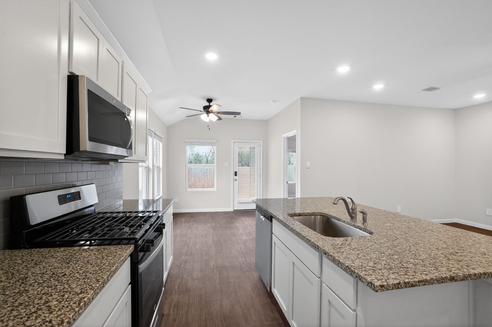206 Addison Place Lockhart, TX 78644 - Photo 8 of 25 a kitchen with stainless steel appliances granite countertop a sink stove and refrigerator