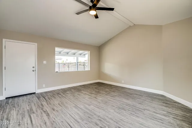 a view of a room with wooden floor and white walls