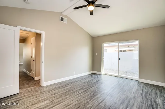 wooden floor in an empty room with a window
