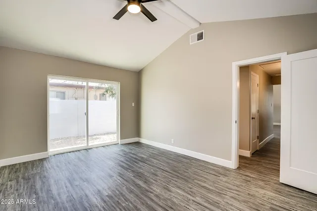 a kitchen with cabinets appliances a sink and a window