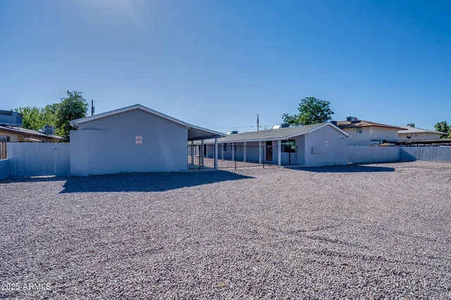 an empty room with wooden floor closet and windows