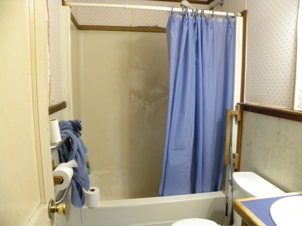 7 Webster Road Ashland, MA 01721 - Photo 9 of 25 a bathroom with a shower and a toilet