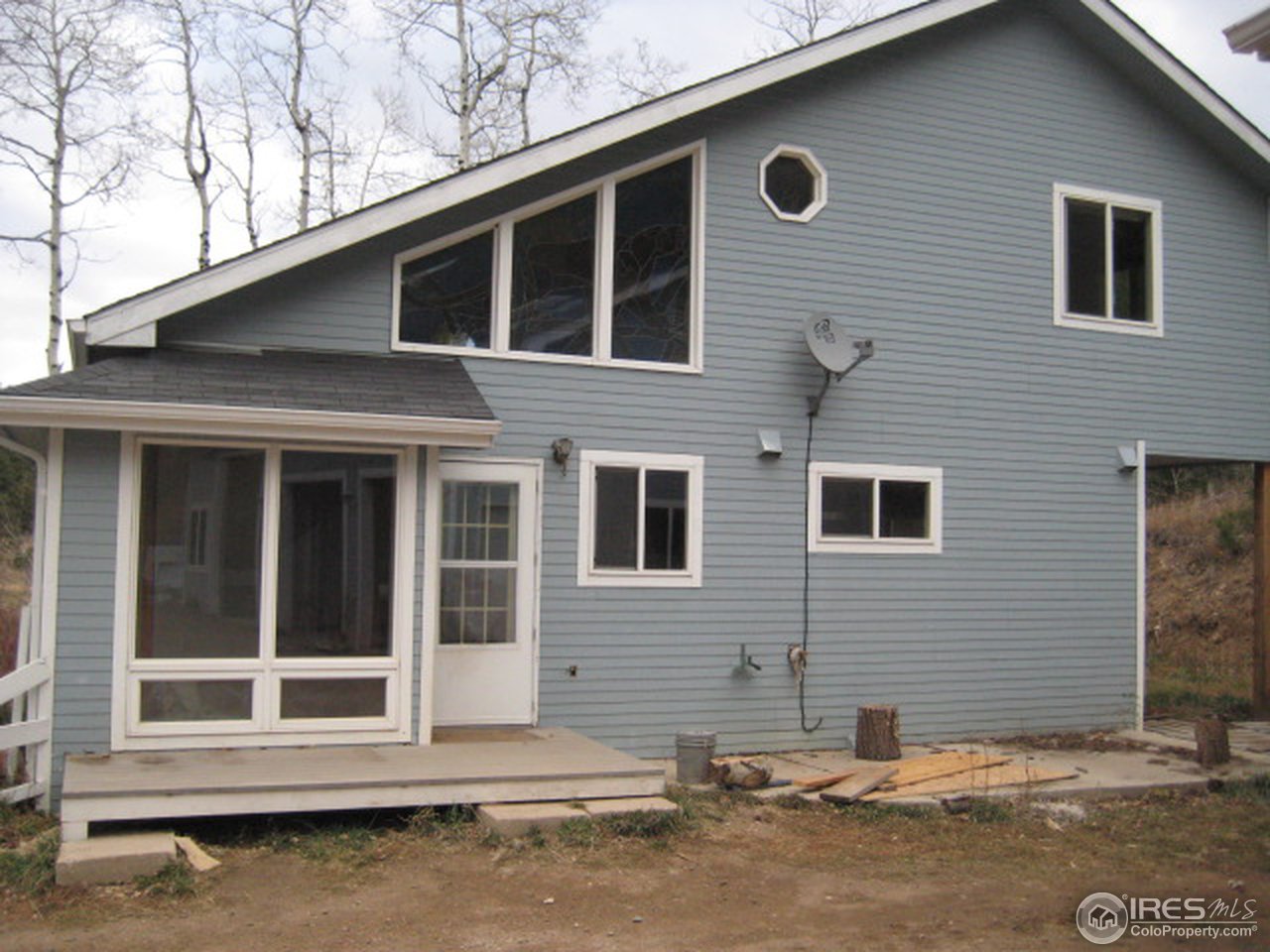 14023 Rist Canyon Road Bellvue, CO 80512 - Photo 3 of 5 a front view of a house with a yard