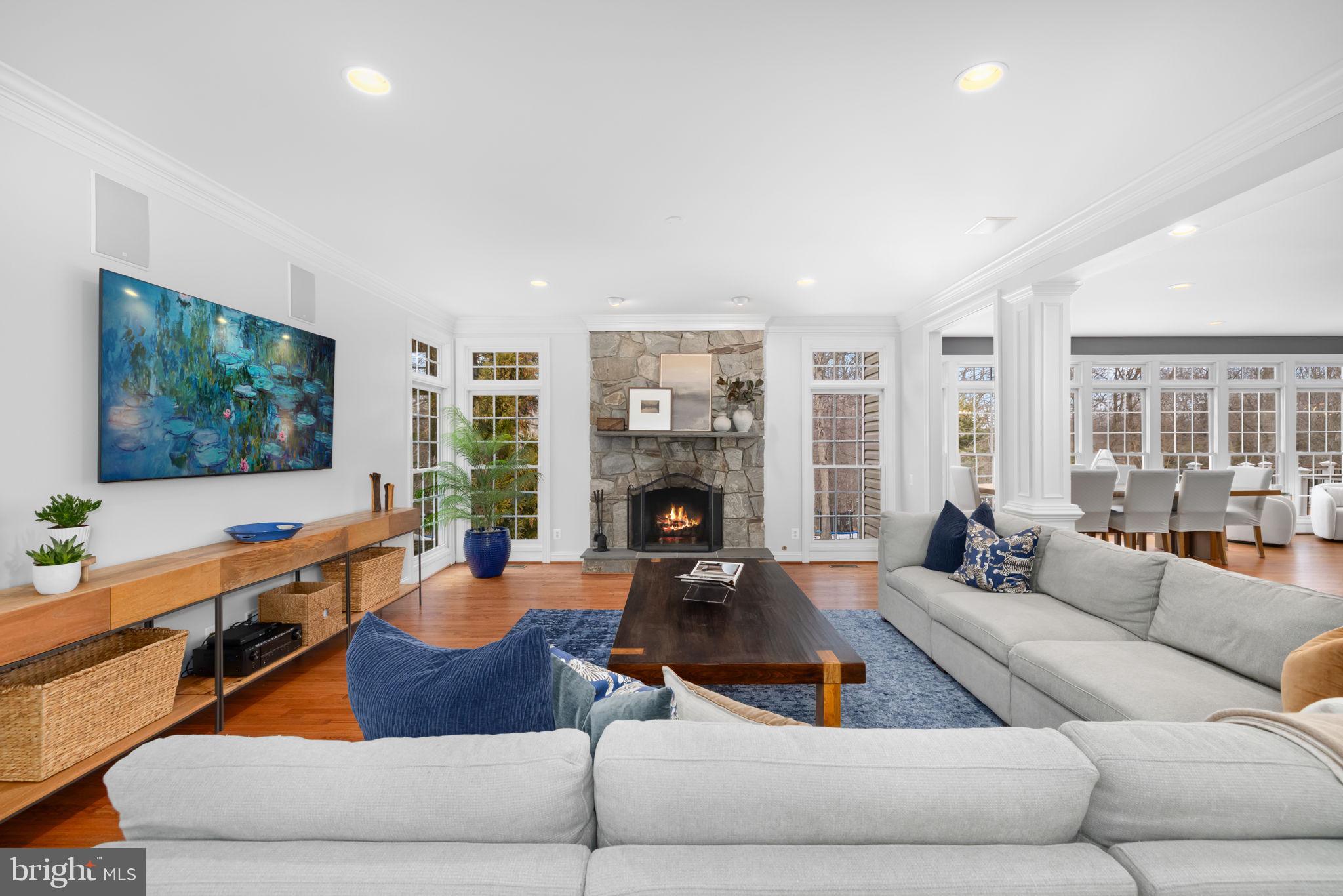 3257 Pony Ridge Way Oakton, VA 22124 - Photo 22 of 67 Gas fireplace with stone flanked by windows