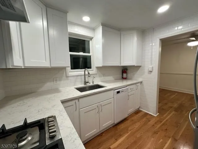 a kitchen with sink cabinets and stove top oven