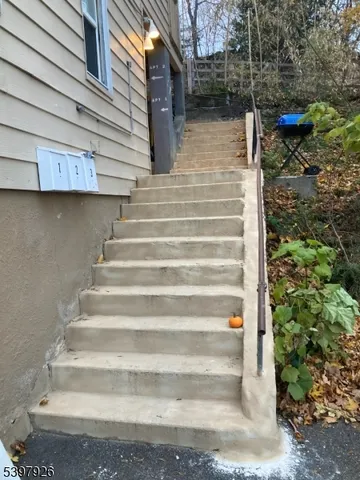 a view of backyard with wooden fence and a potted plant