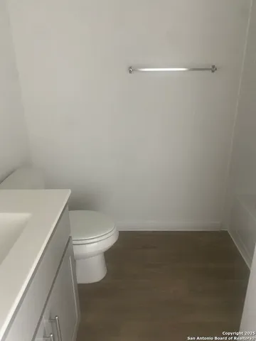a white toilet sitting next to a white sink