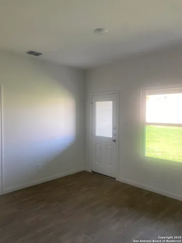 a view of an empty room with a window