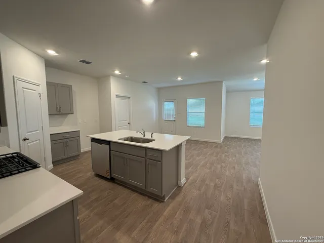 a kitchen with sink stove and refrigerator