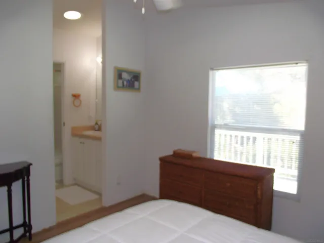 a room with a window and a ceiling fan