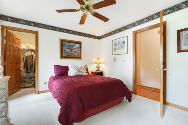 420 Timber Ridge Drive Bartlett, IL 60103 - Photo 11 of 23 a bedroom with a bed and a painting on the wall