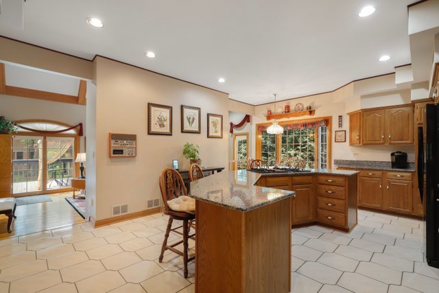 420 Timber Ridge Drive Bartlett, IL 60103 - Photo 3 of 23 a kitchen with granite countertop a sink and cabinets