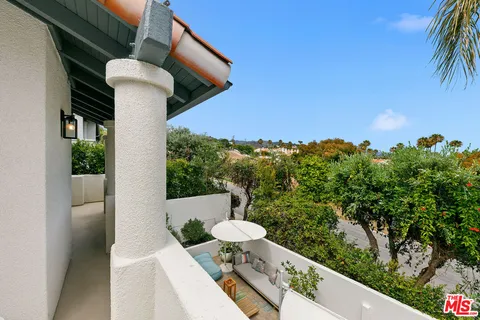 a view of a balcony with furniture