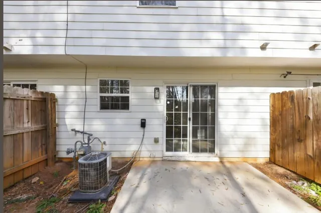 a view of a patio with table and chairs and potted plants